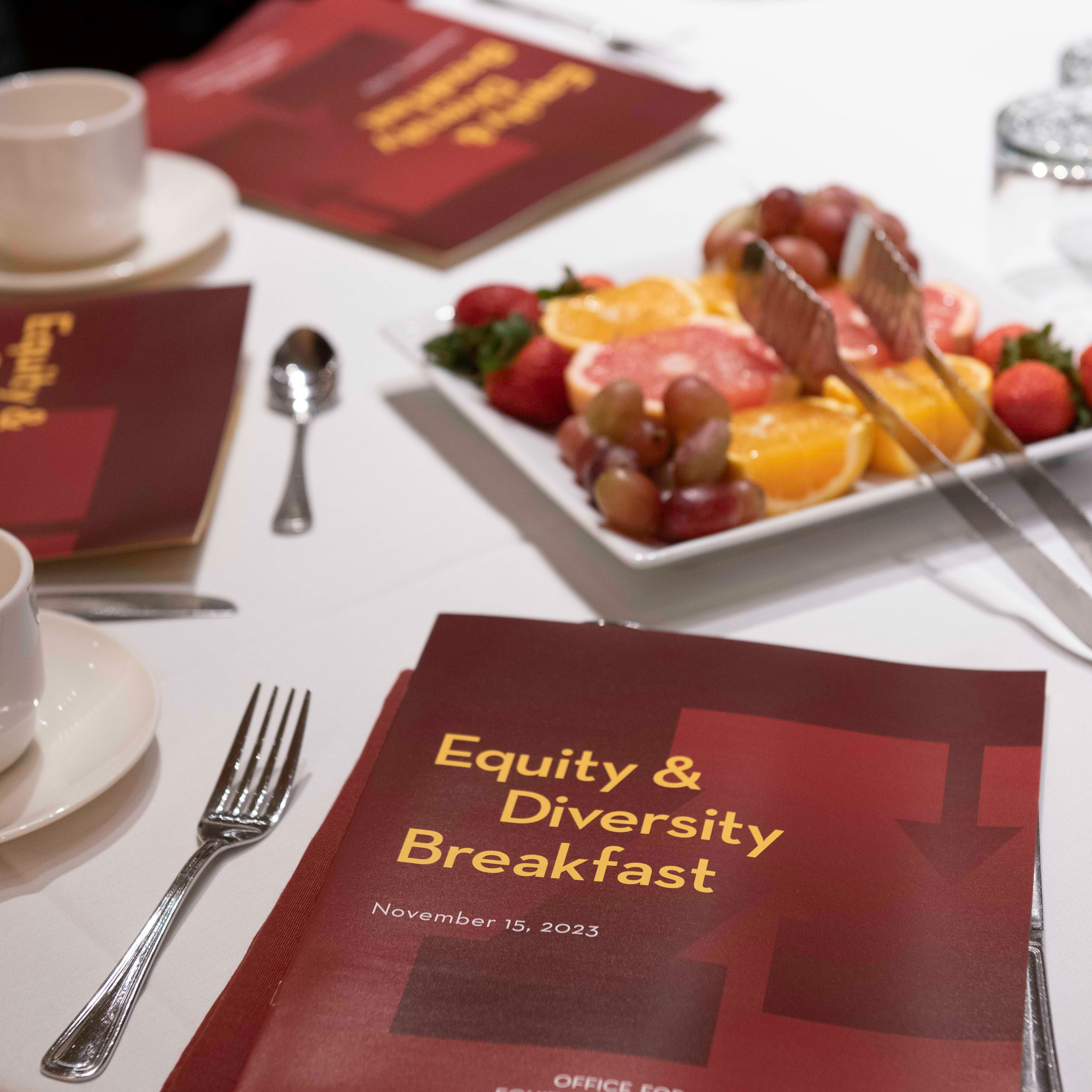 Image of a table setting with a program from the 2023 Equity & Diversity Breakfast