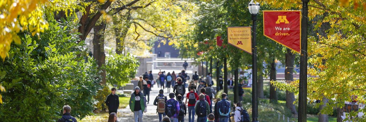 Image of pathway on the Northrop Mall crowded by students, faculty, and staff.